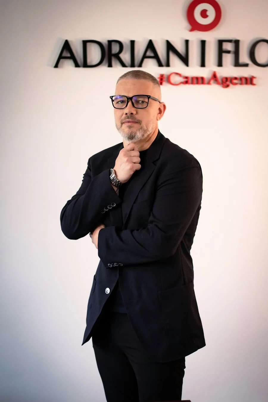 Adrian Florin, în costum negru, în fața siglei Adrian I Florin #CamAgent